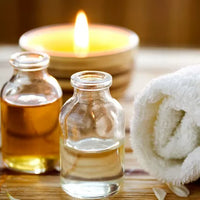 candle, essential oils and spa bath towel