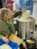 Deb adding soy wax to the melter in her studio