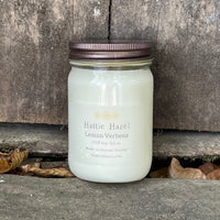 lemon verbena soy candle in clear jar with bronze colored metal lid