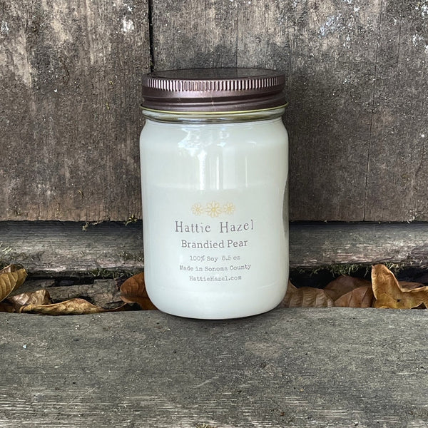 brandied pear soy candle in clear jar with bronze colored lid