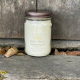 Caramel Popcorn soy candle in clear jar with bronze colored metal lid