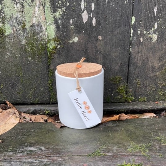 soy candle in white ceramic jar with cork lid