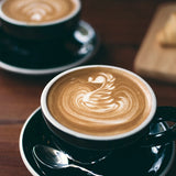 pretty latte in a black cup
