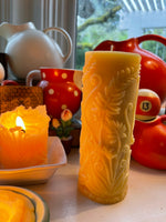 beeswax candle burning and tall fern pillar beeswax candle