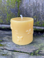 close up of the bee pattern on beeswax candle