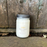 soy candle in a clear jar with metal lid