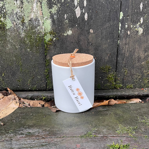 coconut calm soy candle in white matte jar with cork lid