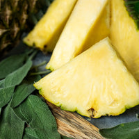 slices of fresh pineapple and sage leaves