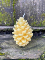 close up of a beeswax candle shaped like a pine cone