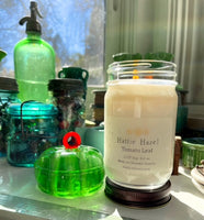 tomato leaf candle in jar on kitchen shelf
